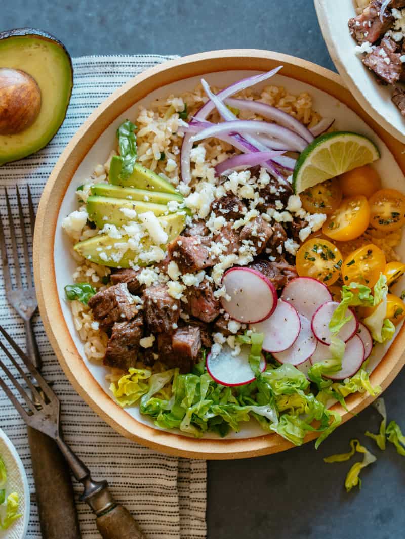 Carne asada bowl with forks.