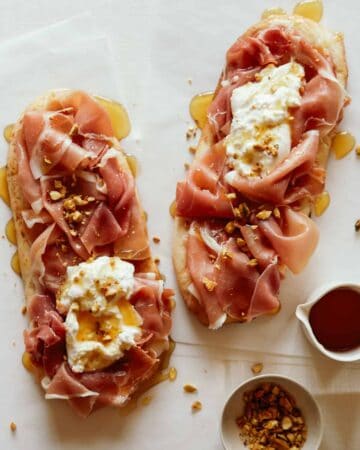 Simple charcuterie flatbreads with honey on the side.