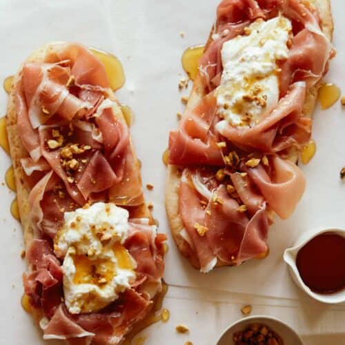 Simple charcuterie flatbreads with honey on the side.