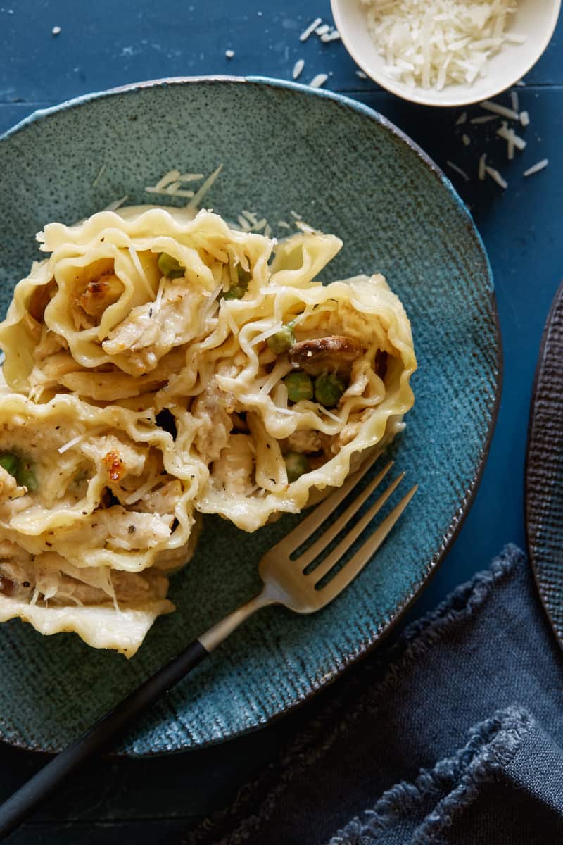 Chicken Alfredo Lasagna roll ups with peas and Parmensan.
