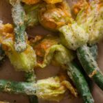A close up of stuffed and fried squash blossoms.
