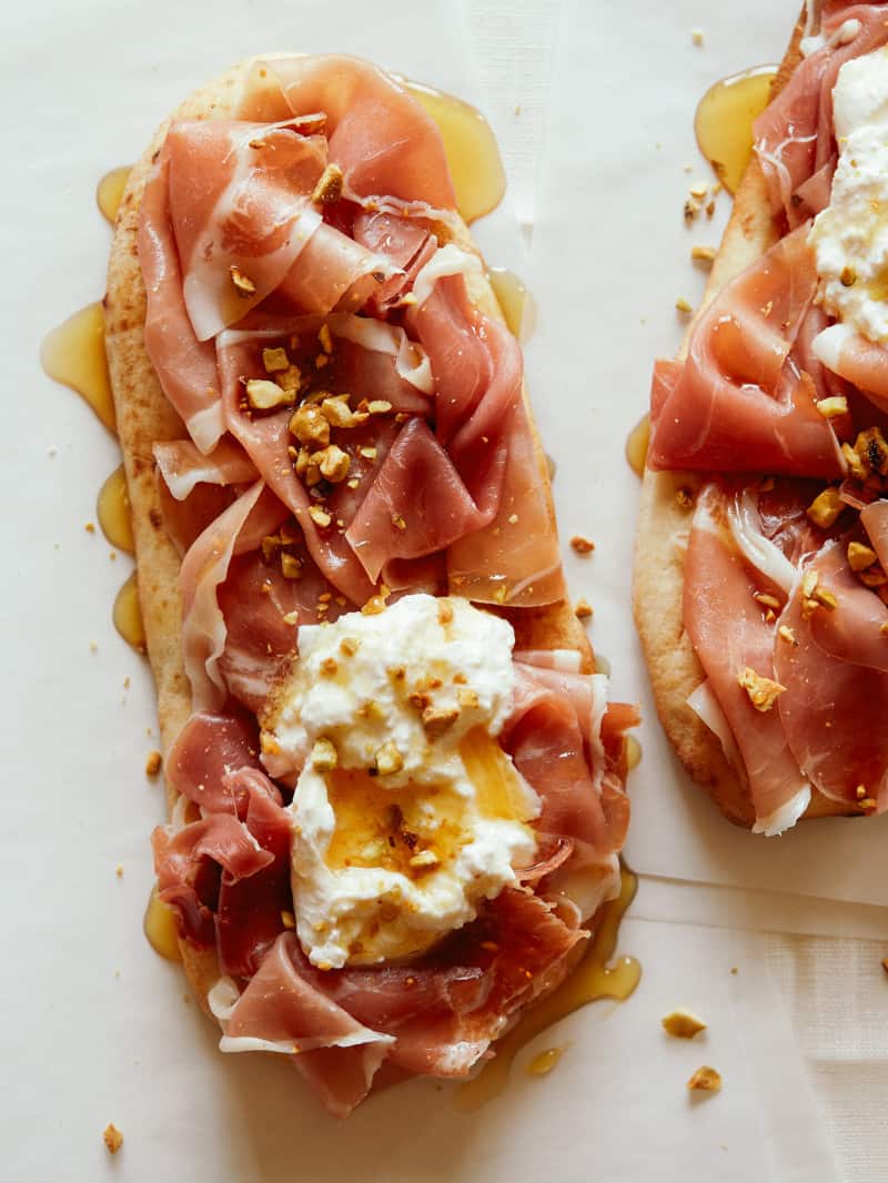 A close up of simple charcuterie flatbreads, an appetizer recipe. 