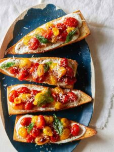 A platter of roasted cherry tomato and whipped feta toast.