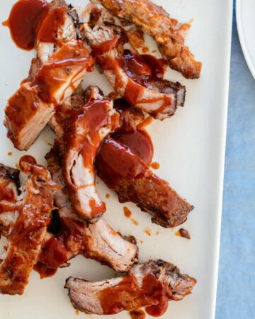 A close up of baby back ribs with sweet honey BBQ sauce.