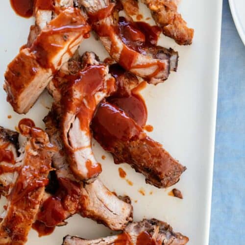 A close up of baby back ribs with sweet honey BBQ sauce.