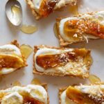 Banana, coconut, and honey cream tarts with a spoon.