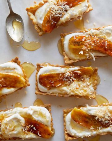 Banana, coconut, and honey cream tarts with a spoon.