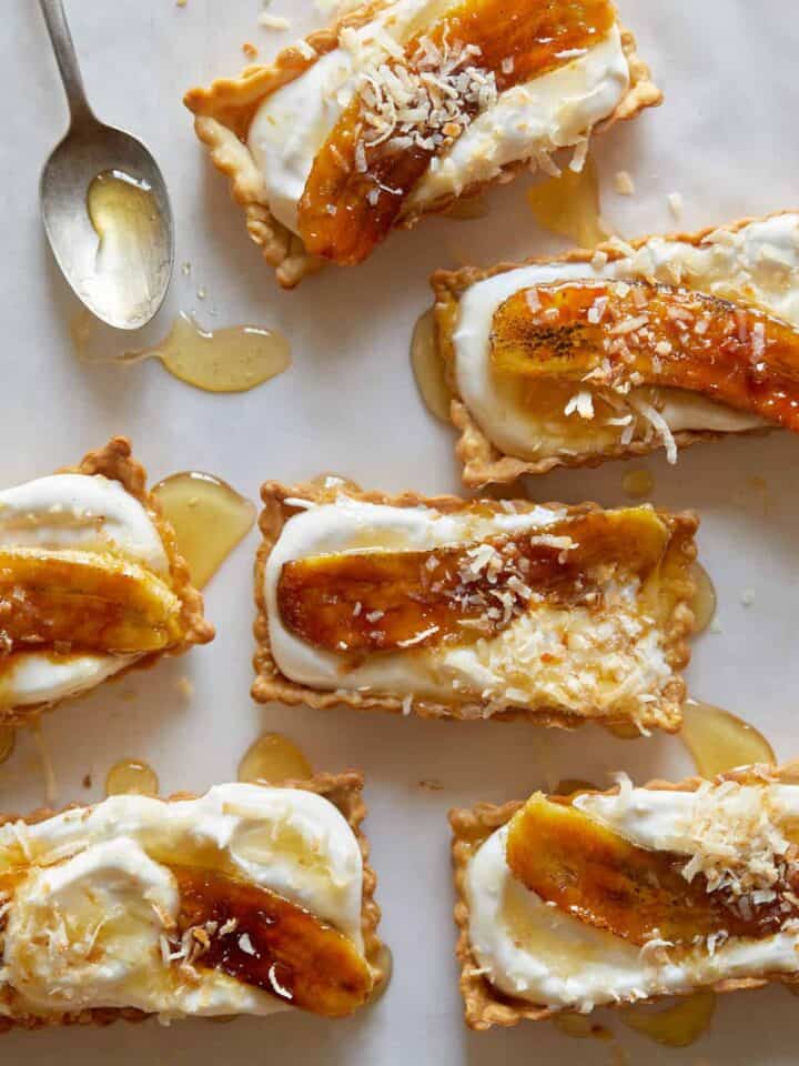 Banana, coconut, and honey cream tarts with a spoon.