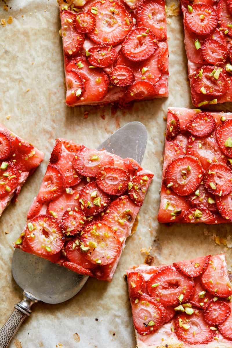 Strawberry Tart cut up with a a serving utensil. 