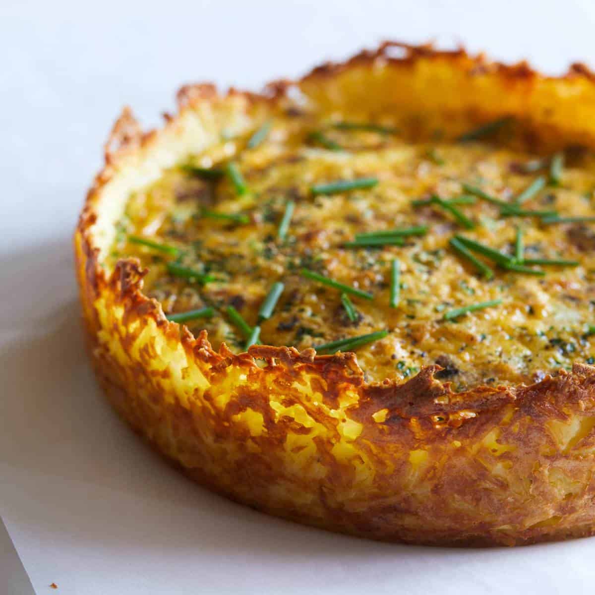 A close up of the hash brown crust on a quiche.