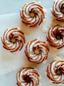 Mini citrus bundt cakes with sweet lemon glaze and lemon zest.