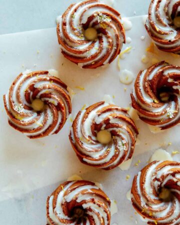 Mini citrus bundt cakes with sweet lemon glaze and lemon zest.
