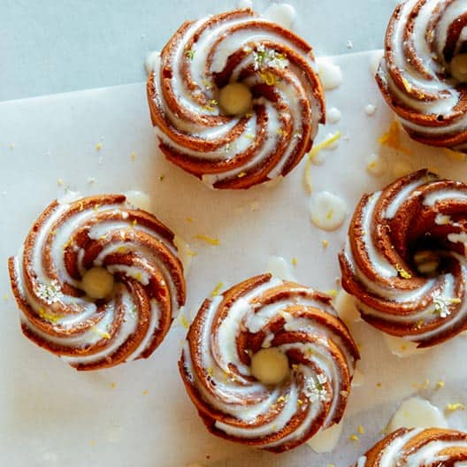 A half dozen mini citrus bunt cakes with lemon glaze.