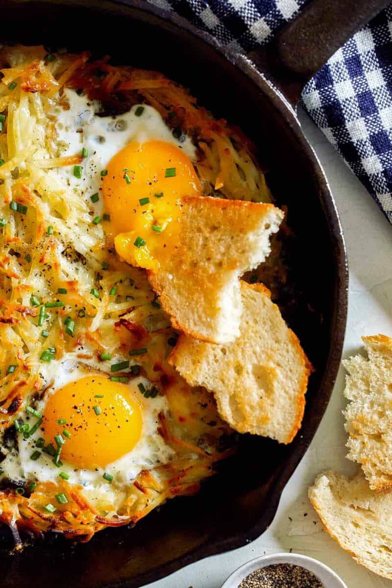 Simple hash browns and eggs in a cast iron skillet.