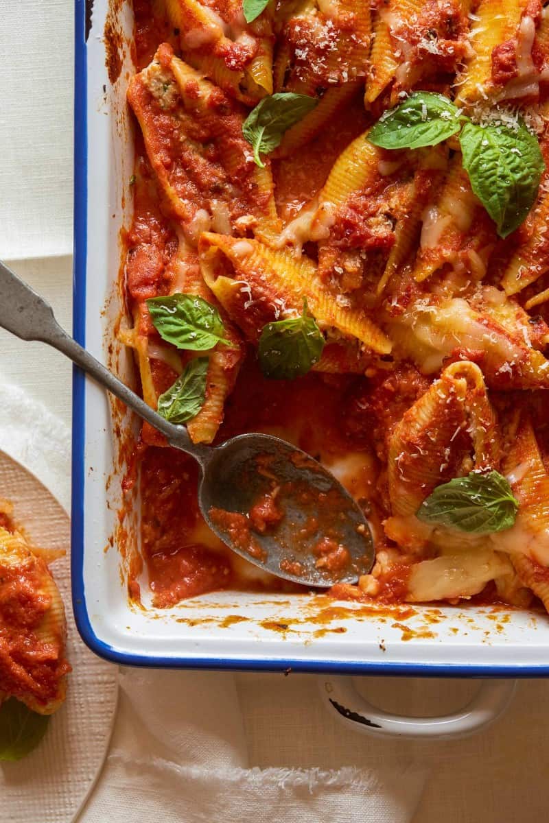 A close up of turkey sausage and mascarpone stuffed shells with a spoon.