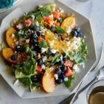 A plate of end of summer fruit salad with forks.