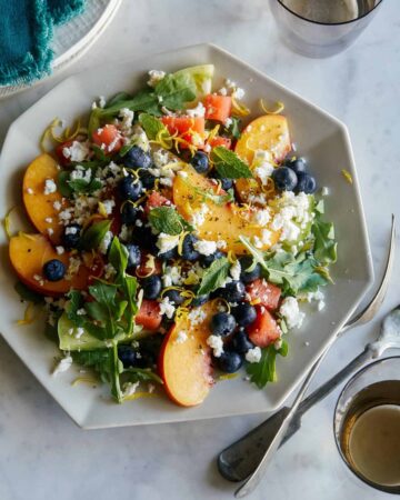 A plate of end of summer fruit salad with forks.