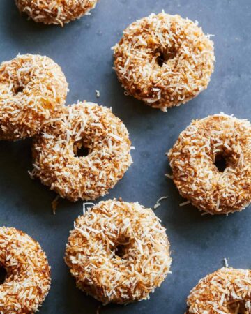 Baked pumpkin cake doughnuts with maple glaze and toasted coconut.