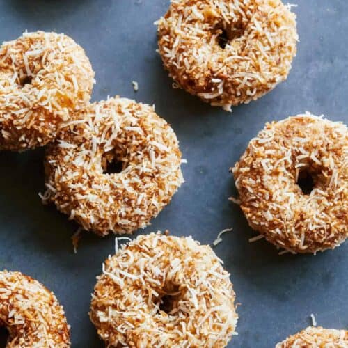 Baked pumpkin cake doughnuts with maple glaze and toasted coconut.