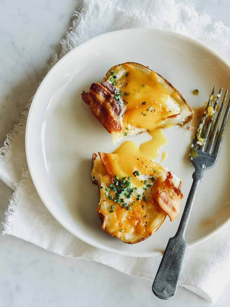 Twice baked breakfast potato cut in half with a fork.