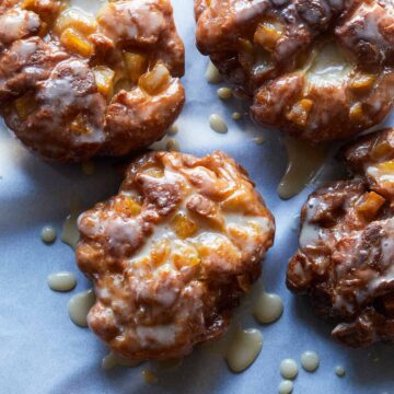 A close up of apple fritters with maple glaze.