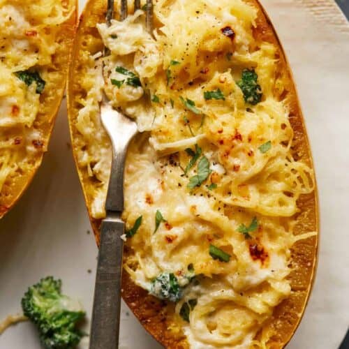 A close up of spaghetti squash and broccoli alfredo with a fork.