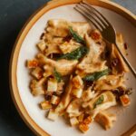 Creamy sweet potato agnolotti on a plate with a fork.