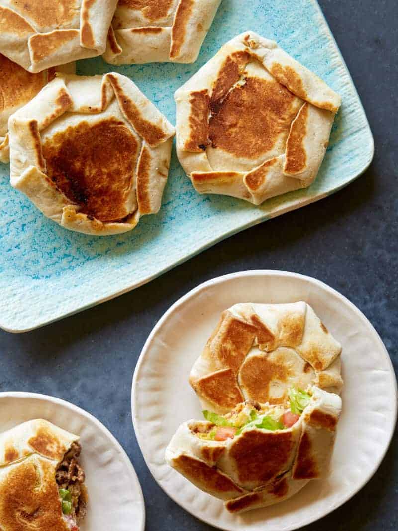 A platter of mini crunchwrap supremes and served on a small plate  for a Super Bowl snack. 