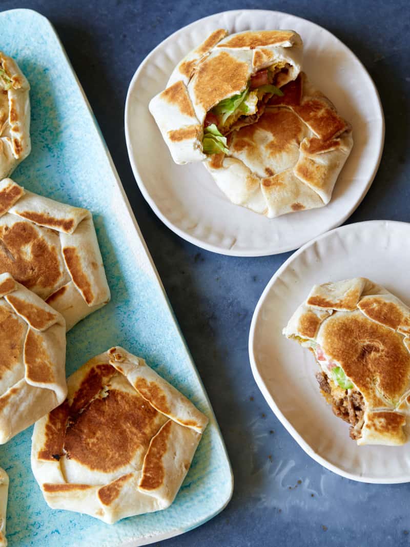 A platter of mini crunchwrap supremes and served on a small plate.