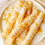 Meyer lemon and ricotta stuffed crepes on a plate.