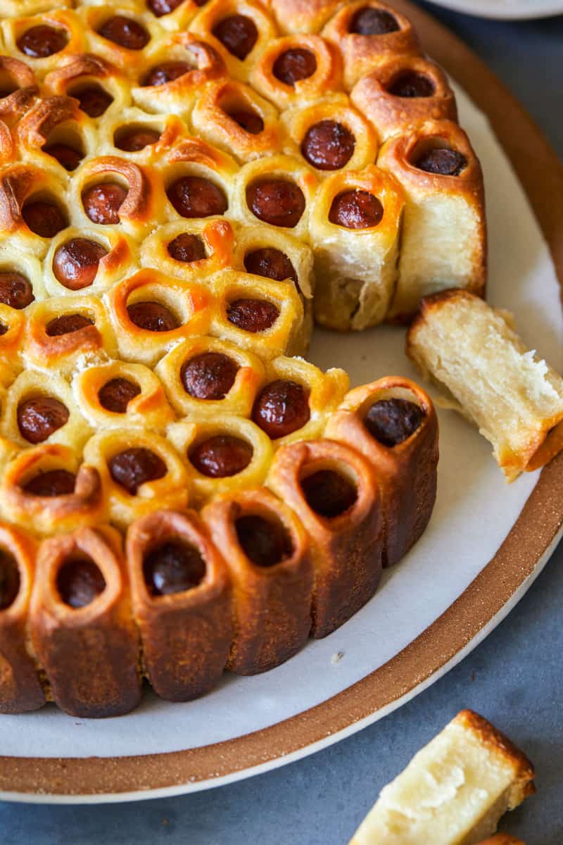 A close up of pull apart pigs in a blanket with some pulled out.