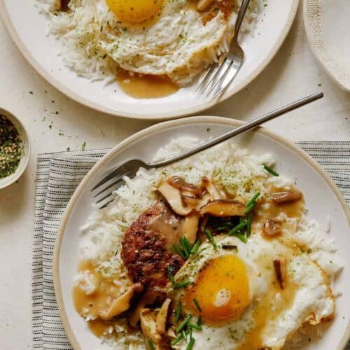 Loco Moco on a plates with a forks.