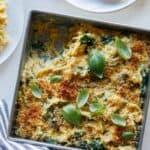 A pan of creamy vegan spaghetti squash, wild mushroom, and spinach bake.