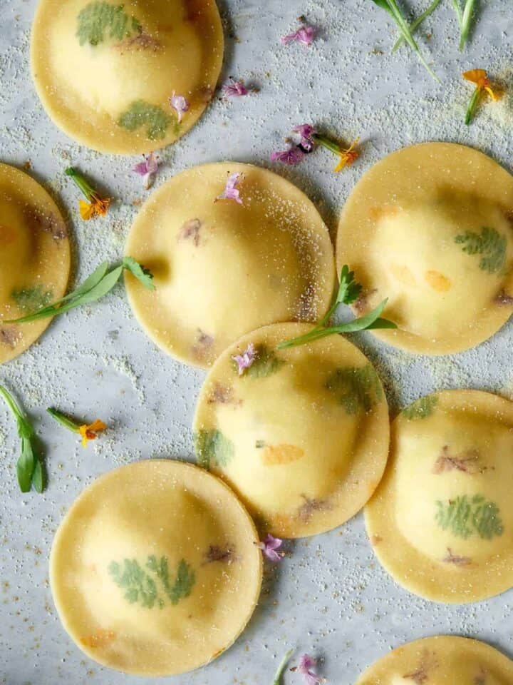 Uncooked floral laced ravioli with cheesy herb ricotta filling.