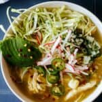 A close up of a bowl of pozole verde de pollo.