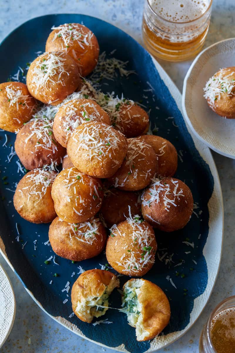 A platter of spinach artichoke stuffed beignets.