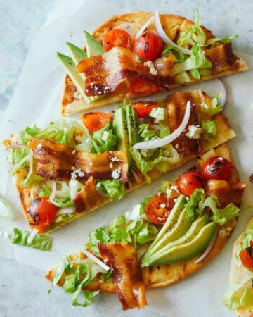 A sliced grilled BLTA flatbread.