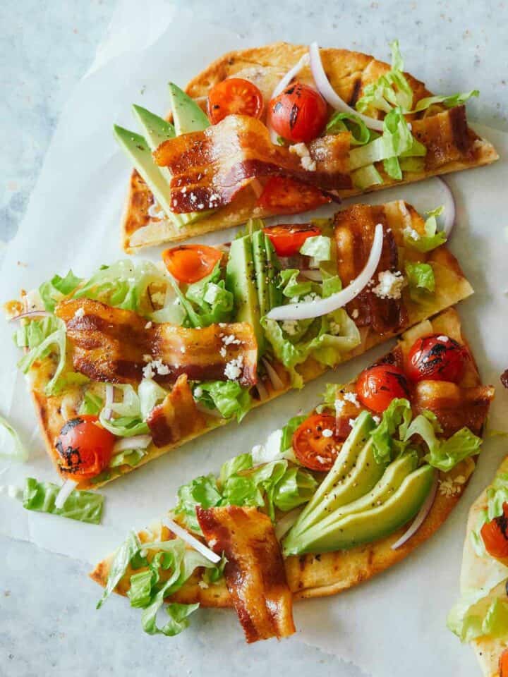 A sliced grilled BLTA flatbread.