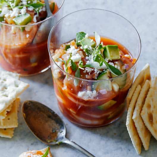 Mexican shrimp cocktail with saltines next to them. 