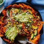 Chipotle lime chilaquiles in a skillet with a spoon.