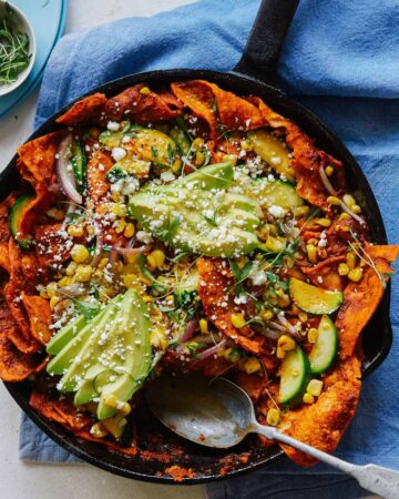 Chipotle lime chilaquiles in a skillet with a spoon.