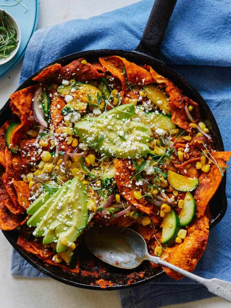 chipotle-lime chilaquiles topped with fanned avocado halves