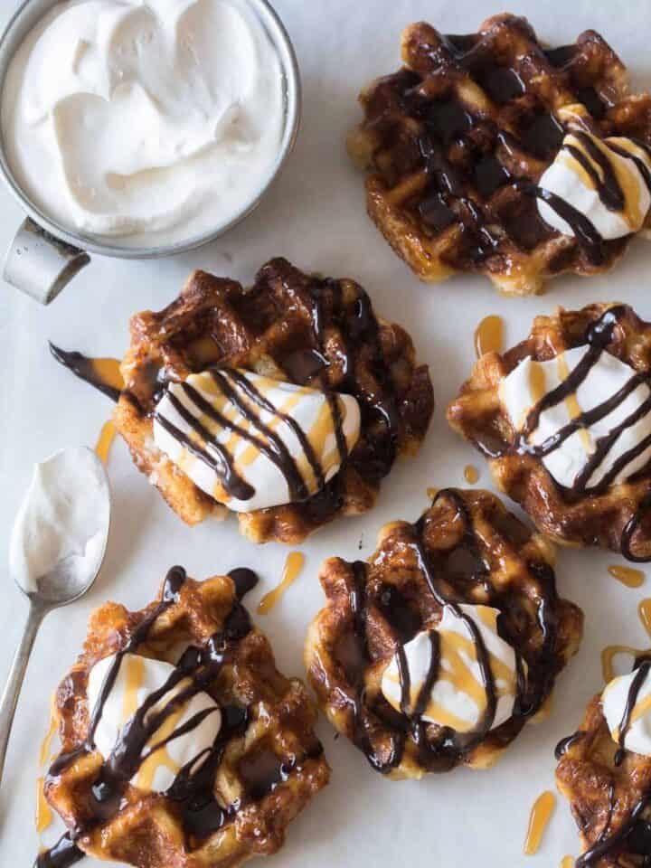 Liege waffles with whipped cream and a spoon on the side.