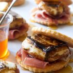 A close up of savory smores with honey.