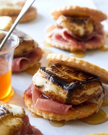 A close up of savory smores with honey.