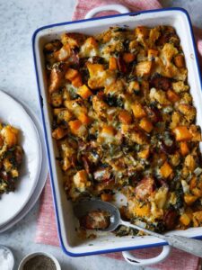 Butternut squash sage stuffing with a spoon and served on a plate.