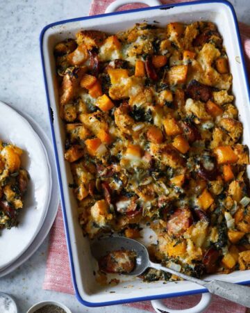 Butternut squash sage stuffing with a spoon and served on a plate.