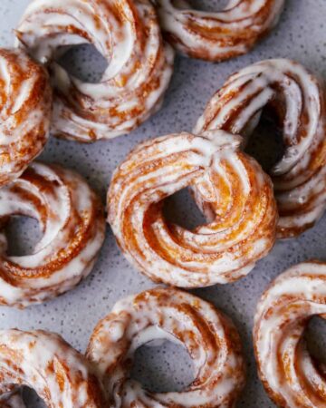 A close up of pumpkin crullers with vanilla bean glaze.