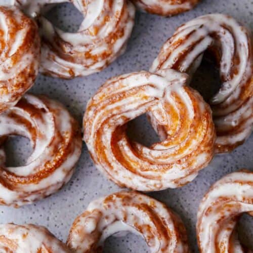 A close up of pumpkin crullers with vanilla bean glaze.