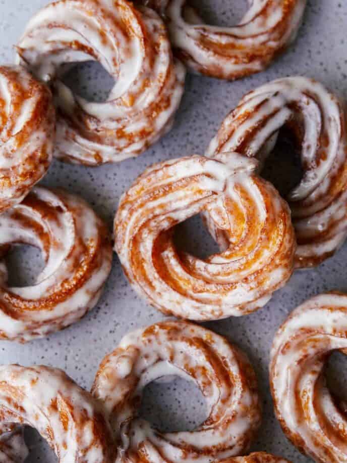 A close up of pumpkin crullers with vanilla bean glaze.